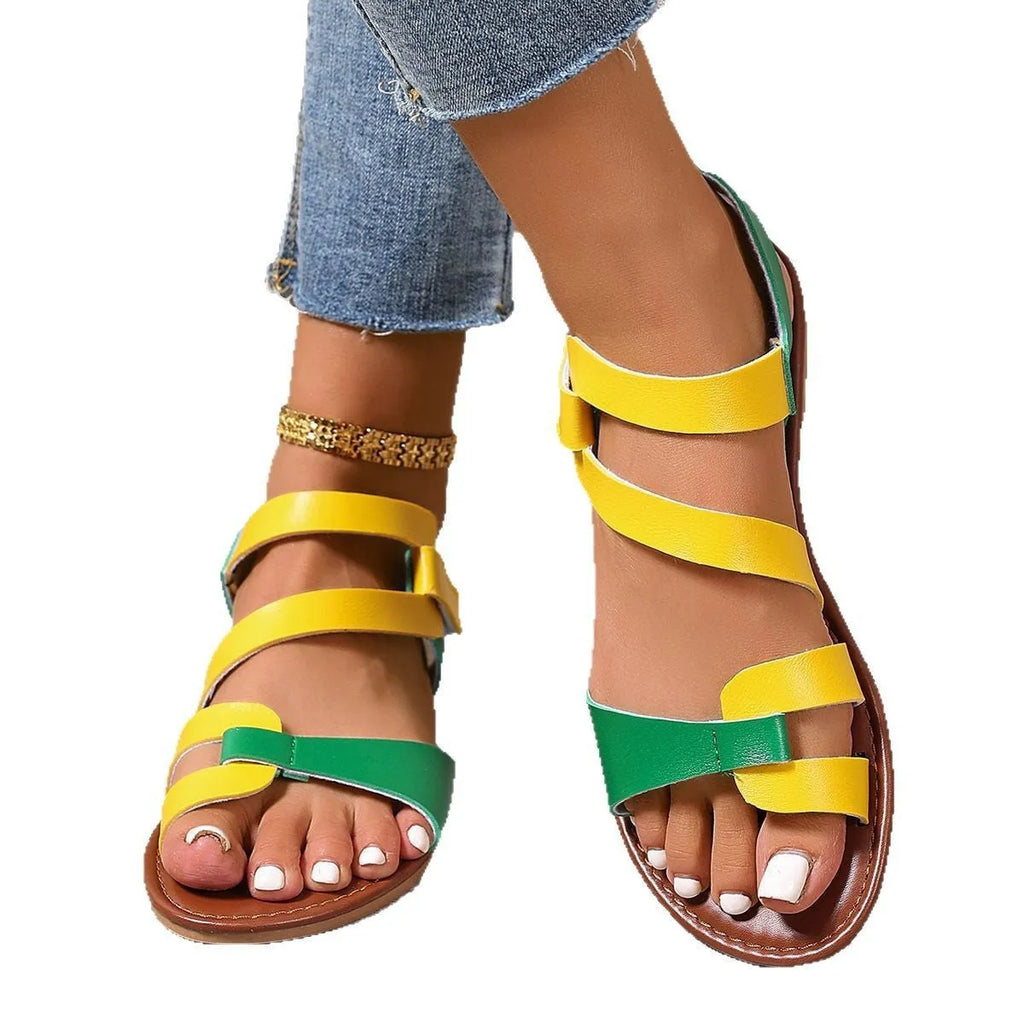 Women's flat sandals with black PU upper and Velcro strap fastening on a rubber sole.