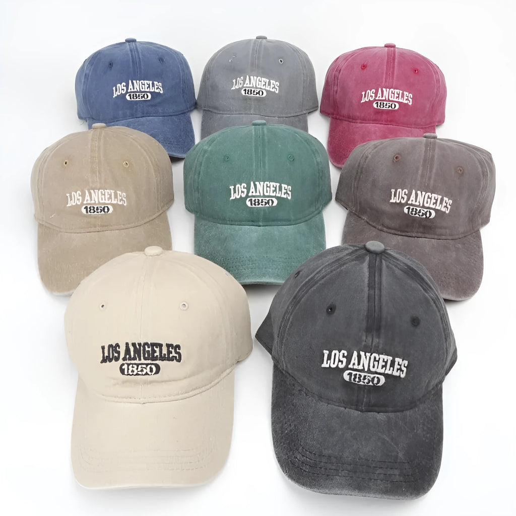 Retro personalised washed distressed embroidered peaked cap in beige colour on a wooden background