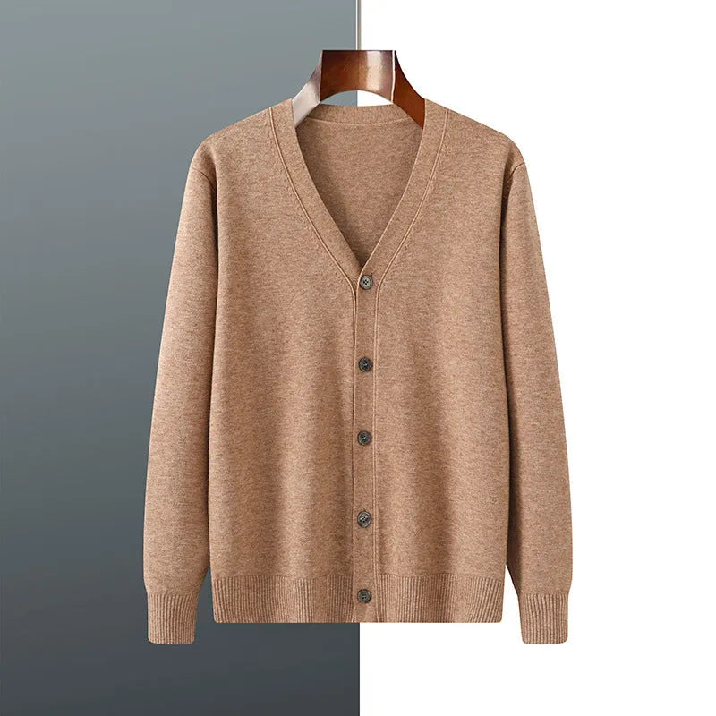 Man wearing a dark blue V-neck Andy velvet knitted cardigan with long sleeves.