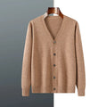 Man wearing a dark blue V-neck Andy velvet knitted cardigan with long sleeves.