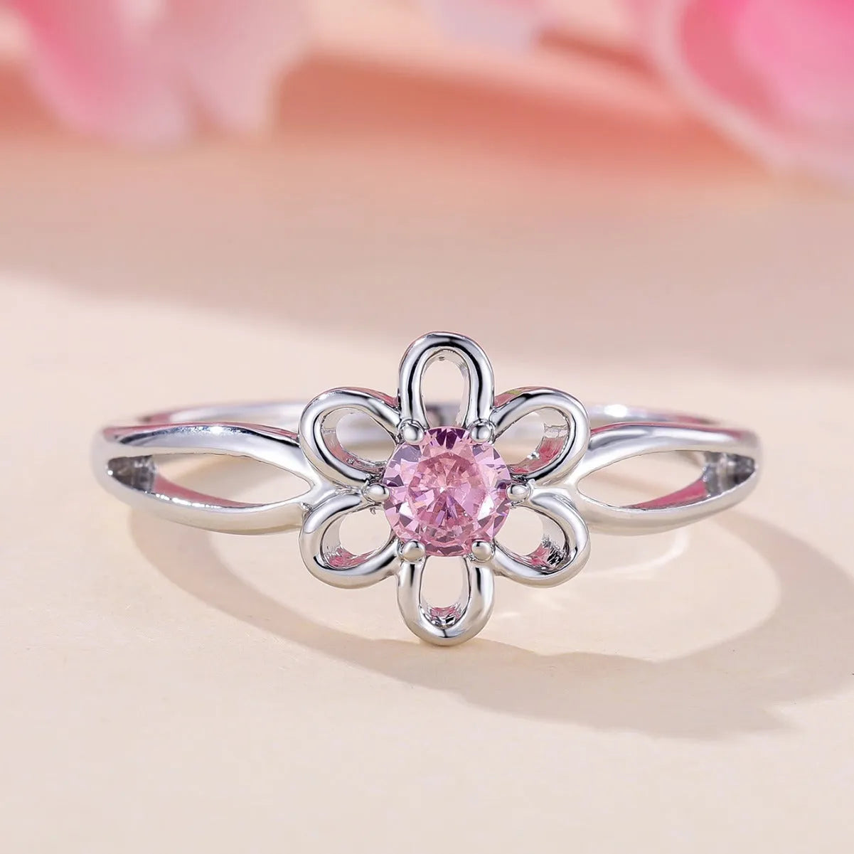 Close-up of a ladies floral hollow ring in electroplated copper with a platinum pink diamond finish.