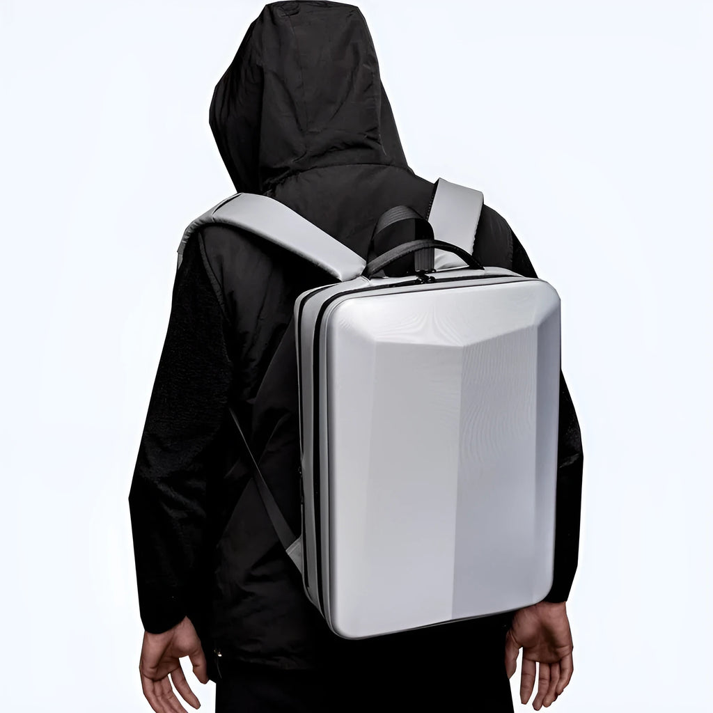 Black waterproof business backpack for 17-inch laptop with curved shoulder straps on a grey background.