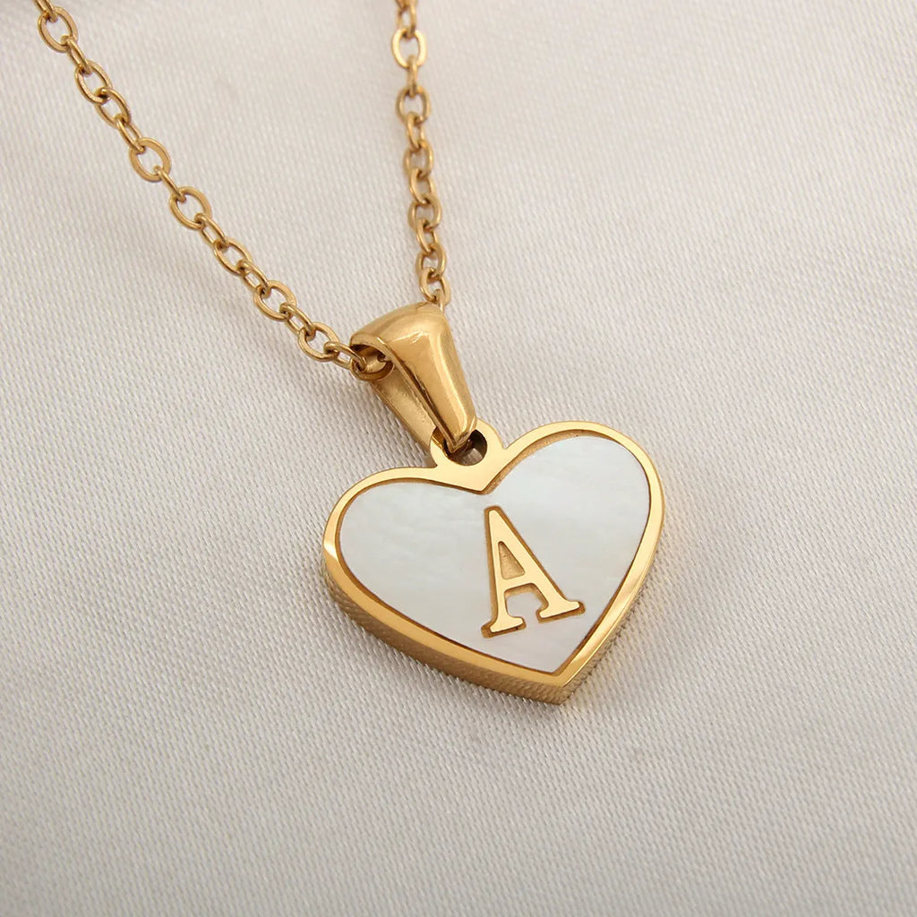Gold-plated heart-shaped white shell pendant necklace on a stainless steel chain with extendable clasp