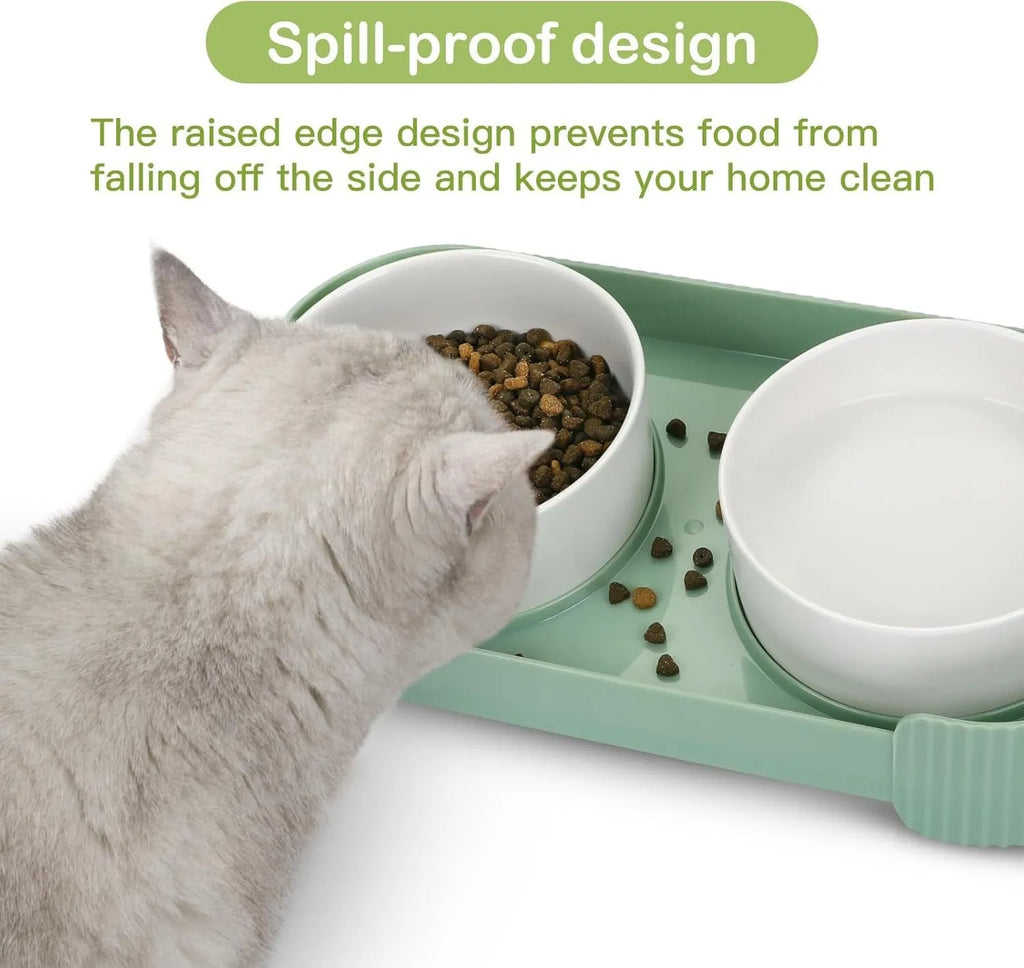 Green ceramic raised cat bowl set with two tilted bowls on a non-slip stand for food and water.