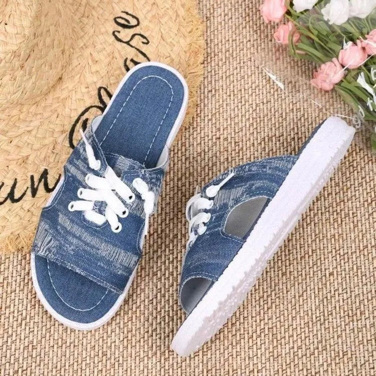 Blue Roman style flat canvas slippers for women with a rubber sole.