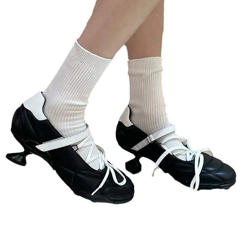 Women's silver sports shoes with lace-up front and decorative bow detail on microfiber upper