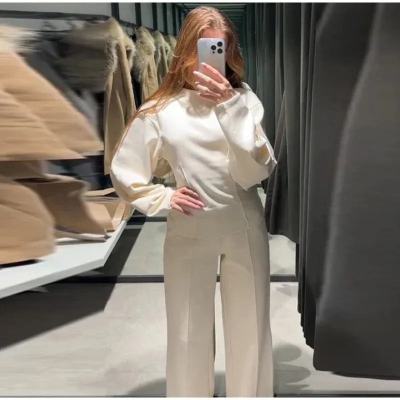 Women's polar fleece suit set showing long sleeve pleated top with wide leg trousers in coordinating colours