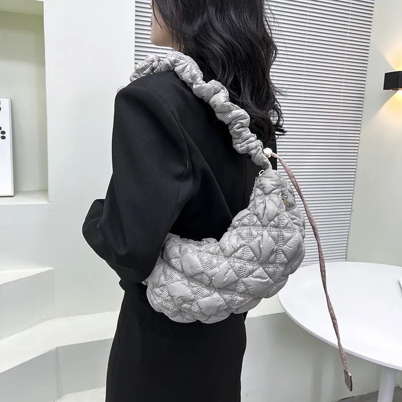 Women's solid colour nylon messenger bag with adjustable shoulder strap.