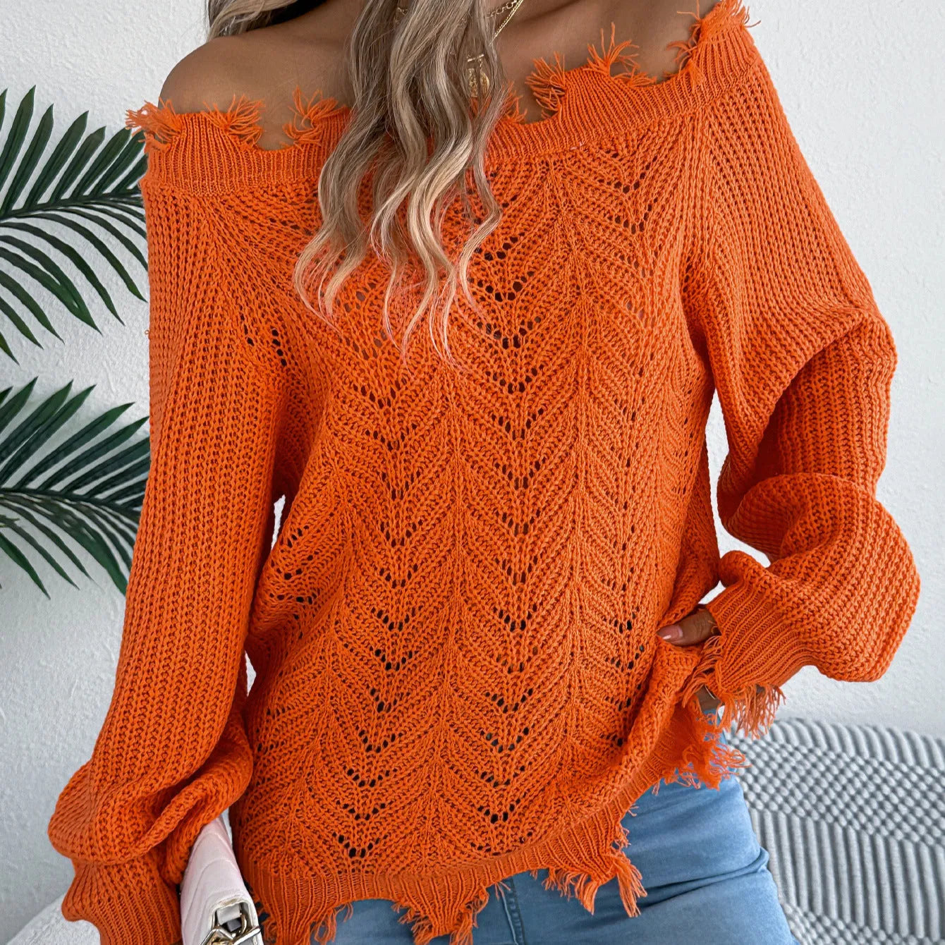 Women's white hollow-out cut-off-shoulder pullover sweater with regular sleeves on hanger