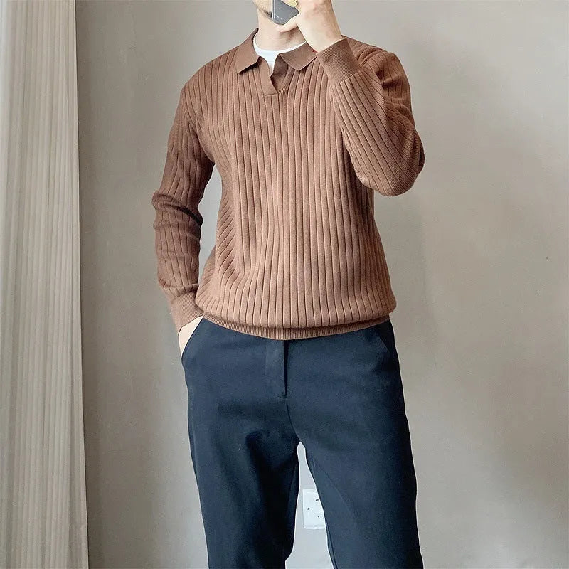 Man wearing a black and white striped knitted jumper with a lapel collar.
