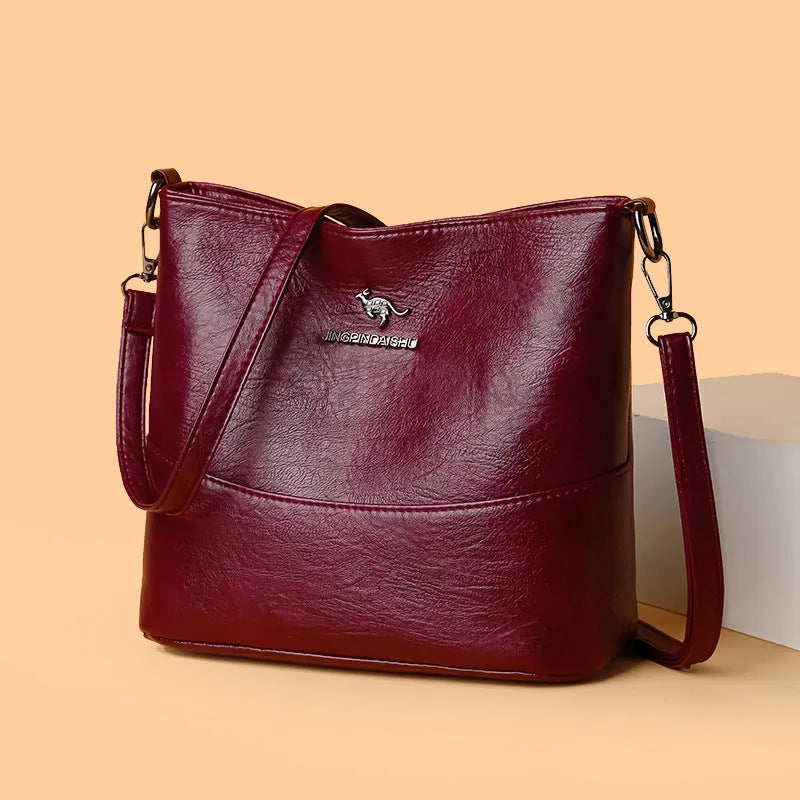 Women's leather bucket shoulder bag in solid colour with phone pocket and sandwich pockets