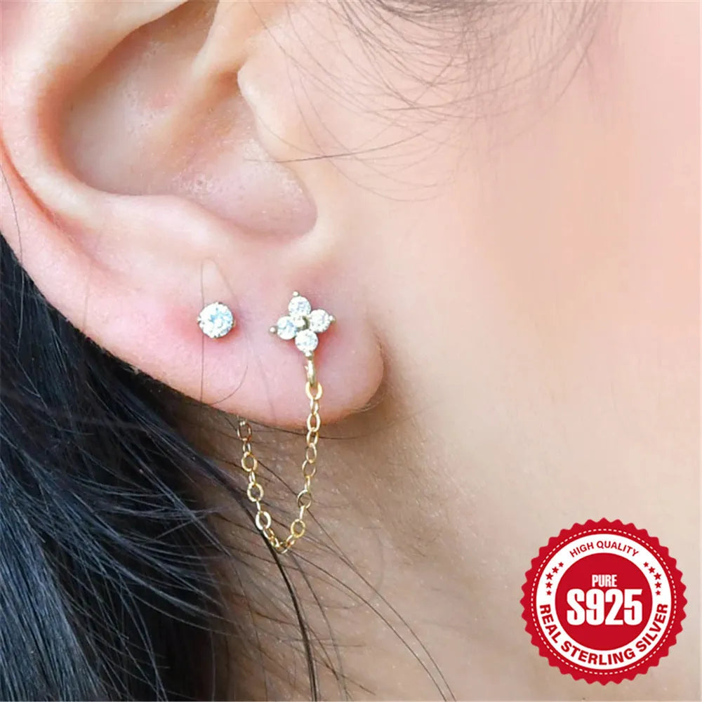 S925 sterling silver ear stud with a geometric diamond flower design and delicate tassel chain detailing in a gold tone finish.