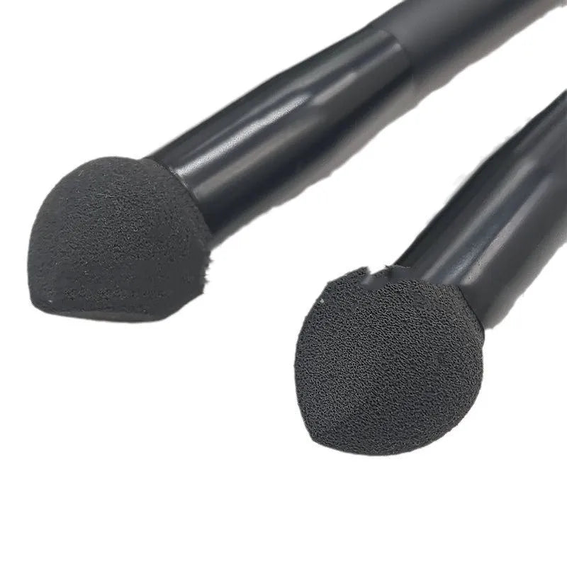 Black foam sponge tip concealer brush with a wooden handle for under-eye makeup application.