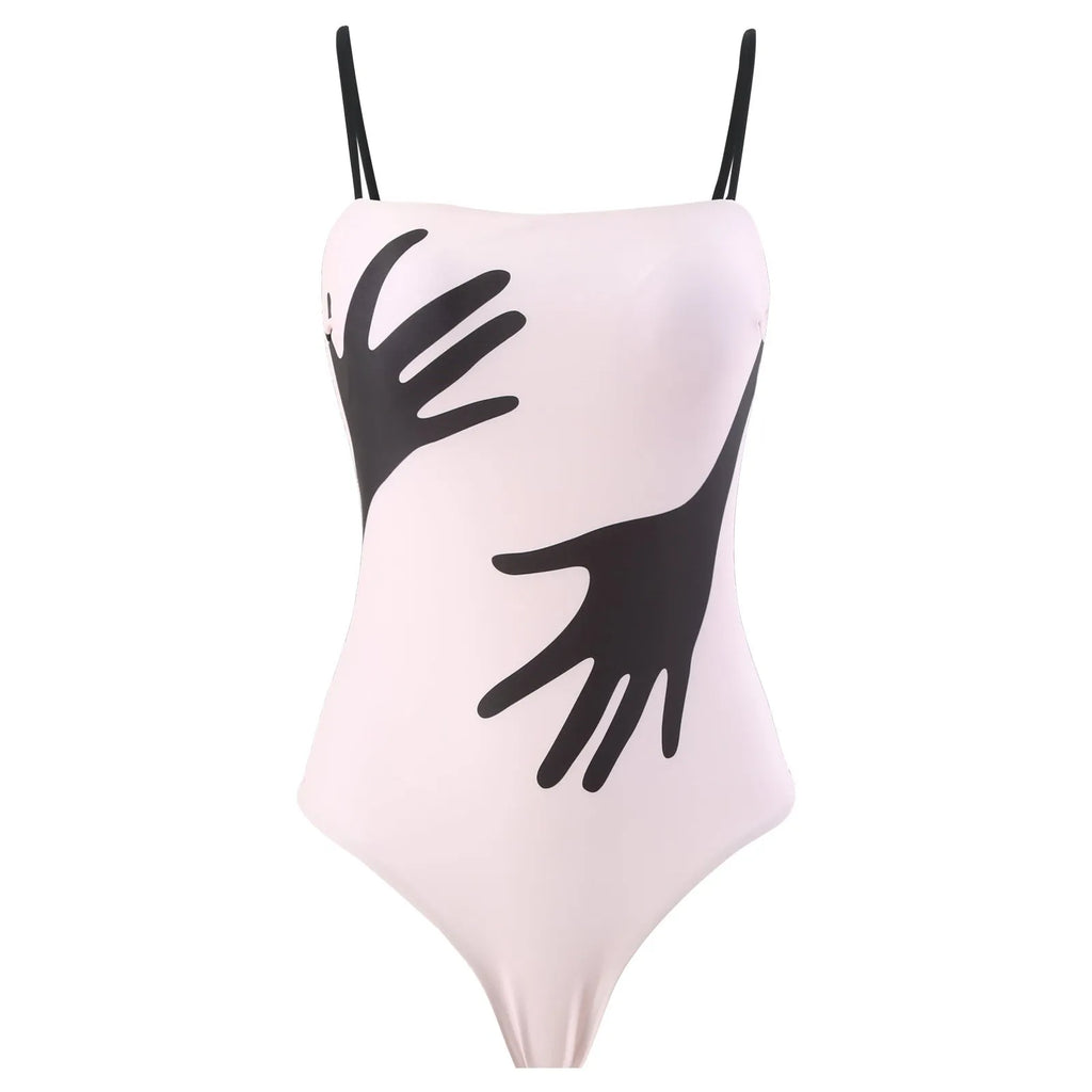 Women's patterned one-piece bikini swimsuit with a separate white tulle skirt laid flat.