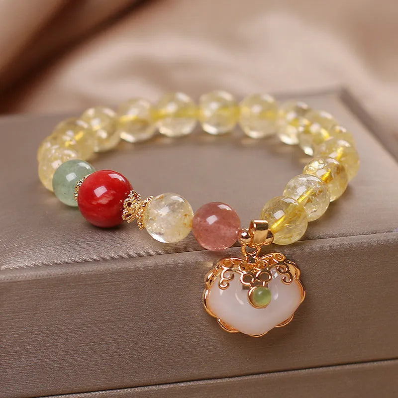 Yellow citrine jade ruyi pendant on an alloy women's bracelet.