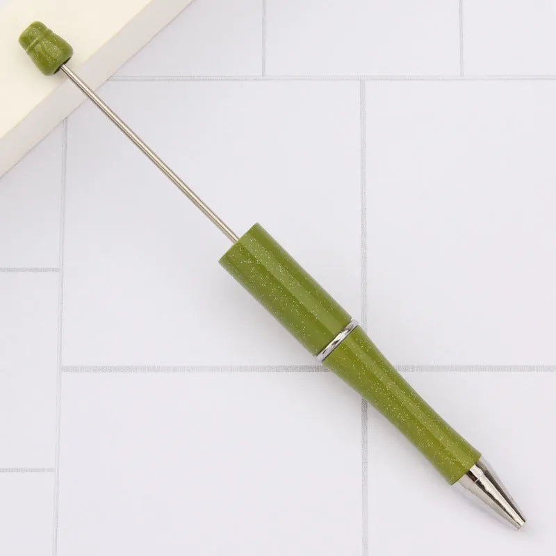Ballpoint pen with colourful spinning plastic beads on barrel, shown in a gradient purple finish.