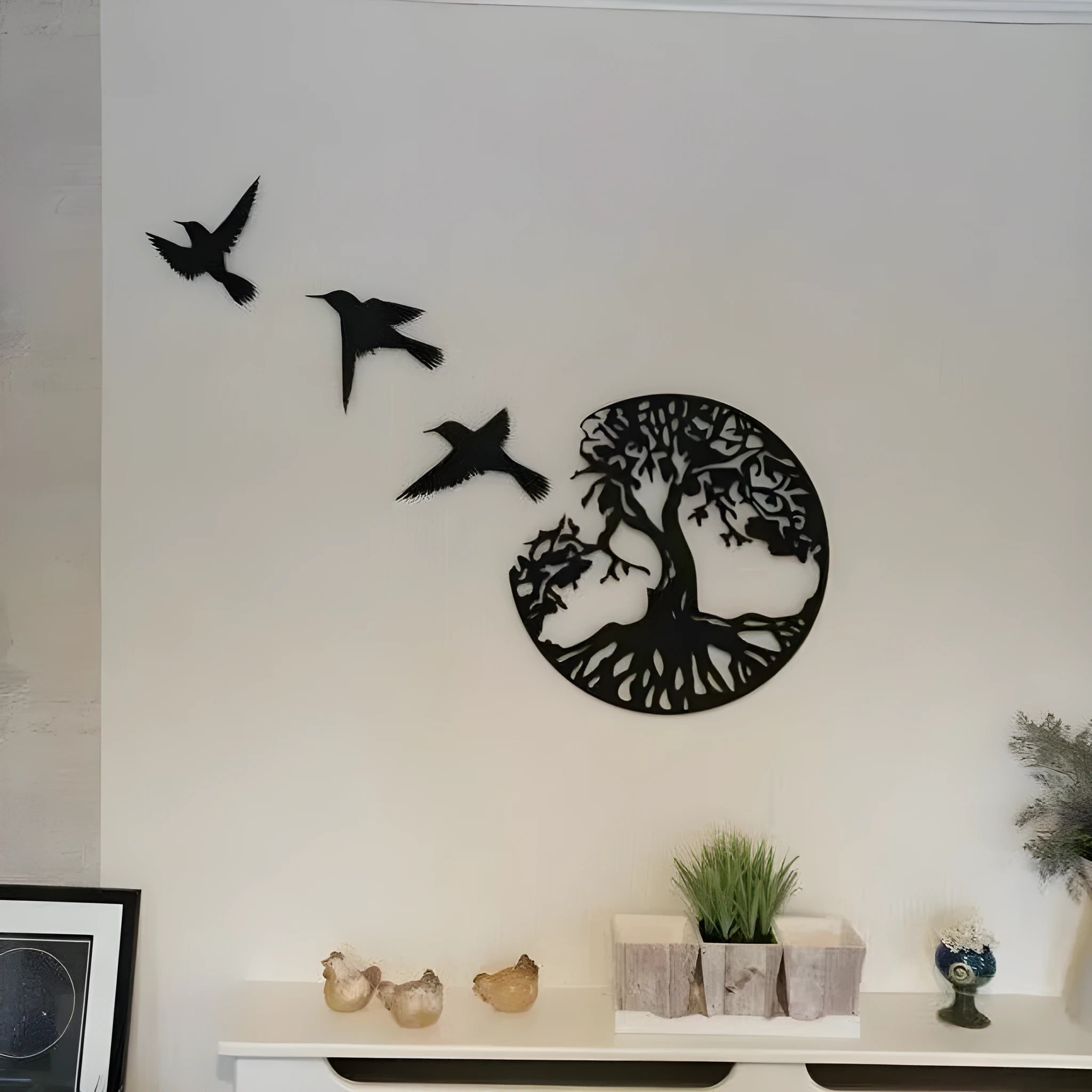 Black modern iron wall hanging with electroplated finish and hanging strap.