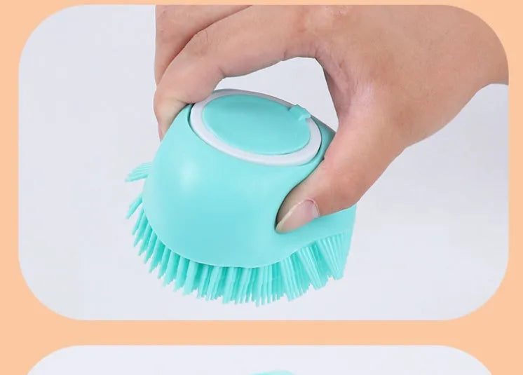 Blue silicone dog bath brush with soft bristles, shown on a hand.