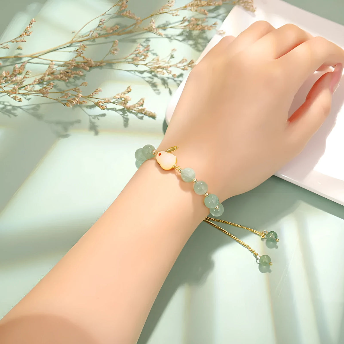 Rabbit charm bracelet with natural stone beads on copper-plated chain with gold accents