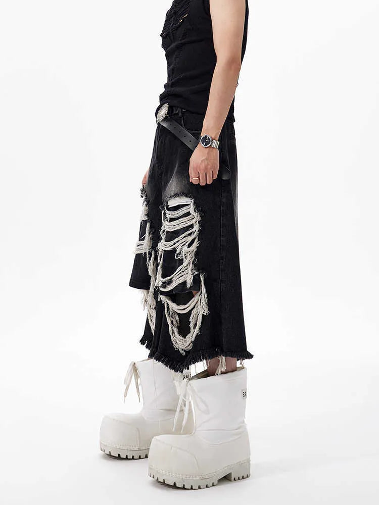 Women's black cropped wide leg jeans with distressed ripped patches and high waist