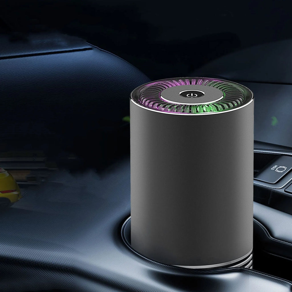 Compact black car air purifier with aluminium alloy body, shown with power cord.