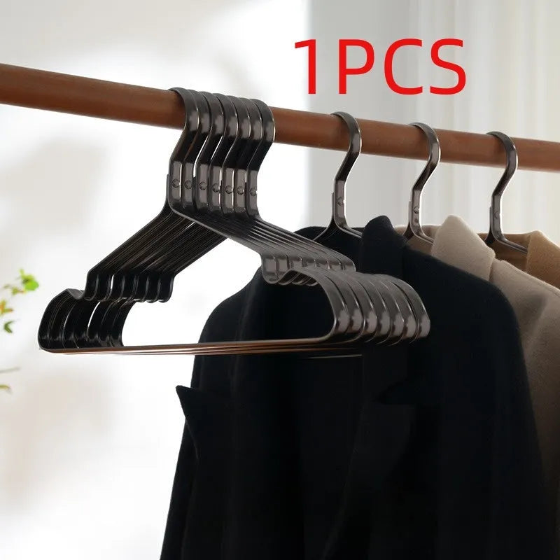 Elegant black metal clothes hanger with anti-slip and anti-rust coating on a white background.
