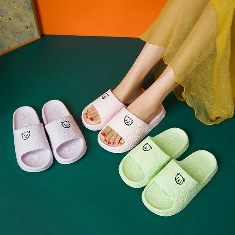 Pair of cute bear EVA indoor slippers in pink with thick non-slip soles.