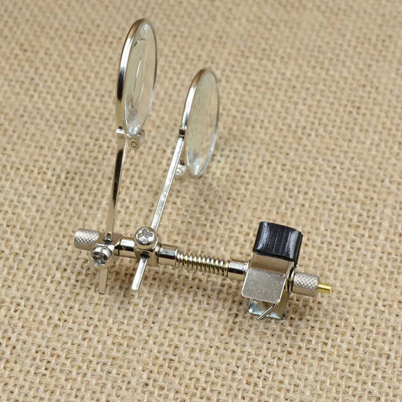 Metal and glass reading glass mirror with double clip for attaching to spectacles.