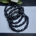 Unisex adjustable bracelet with rough, dark black tourmaline beads on a black cord.