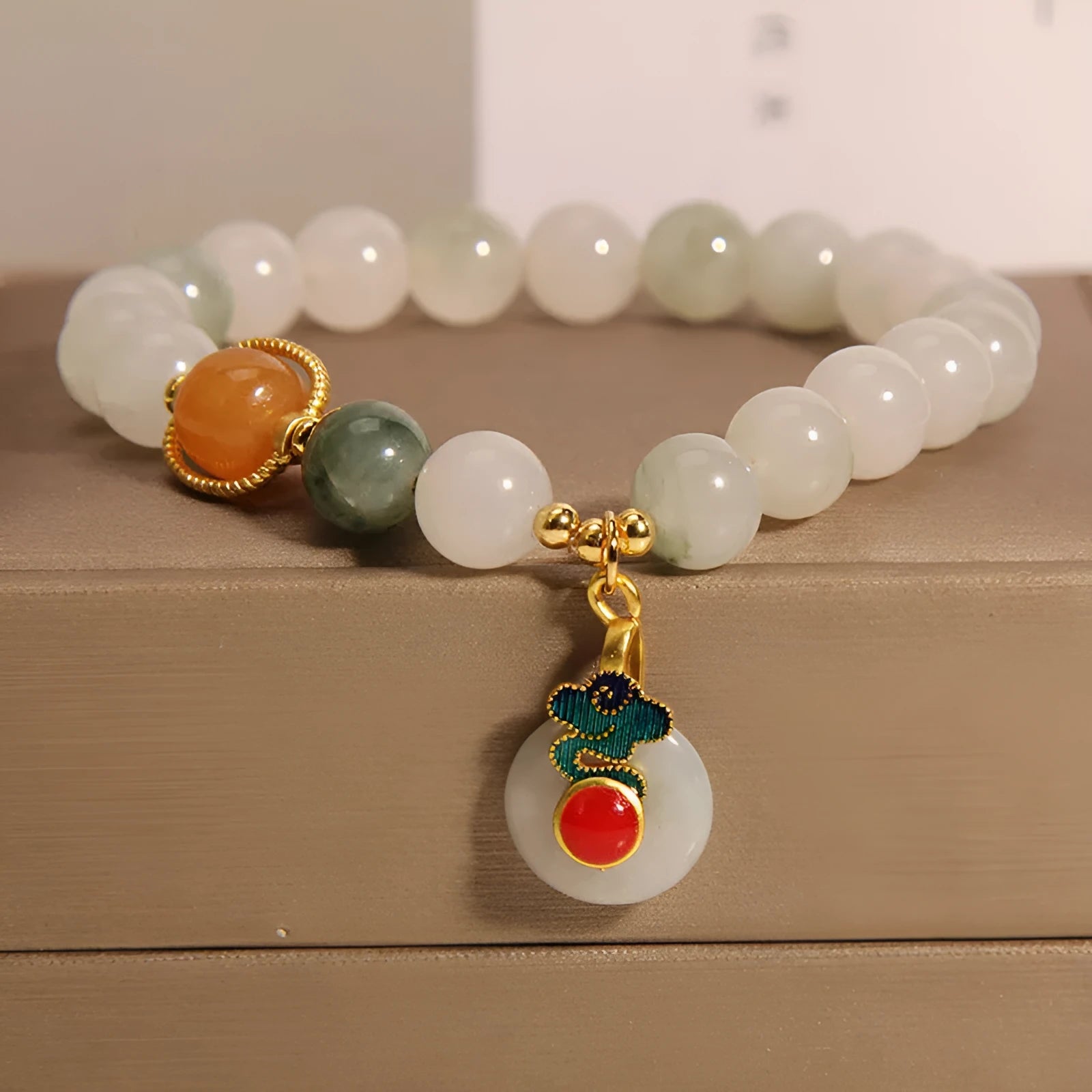 Women's ice jade bracelet with pearl accents and traditional Xiangyun peace buckle closure
