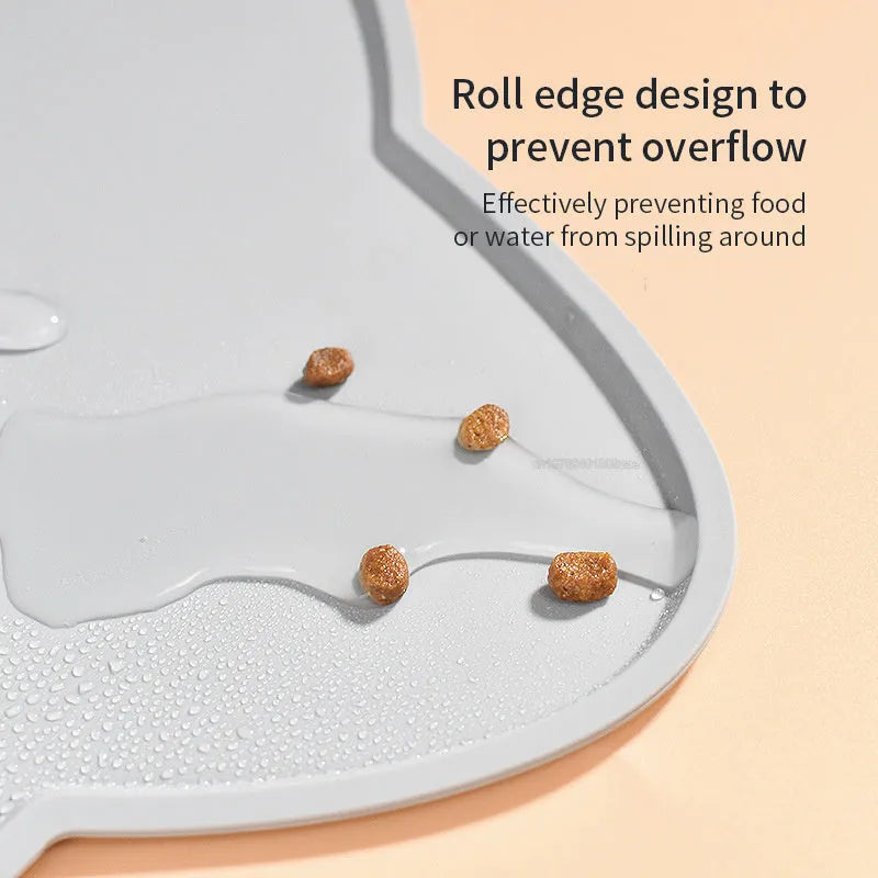 Blue silicone pet feeding mat with cat head shape under dog bowl
