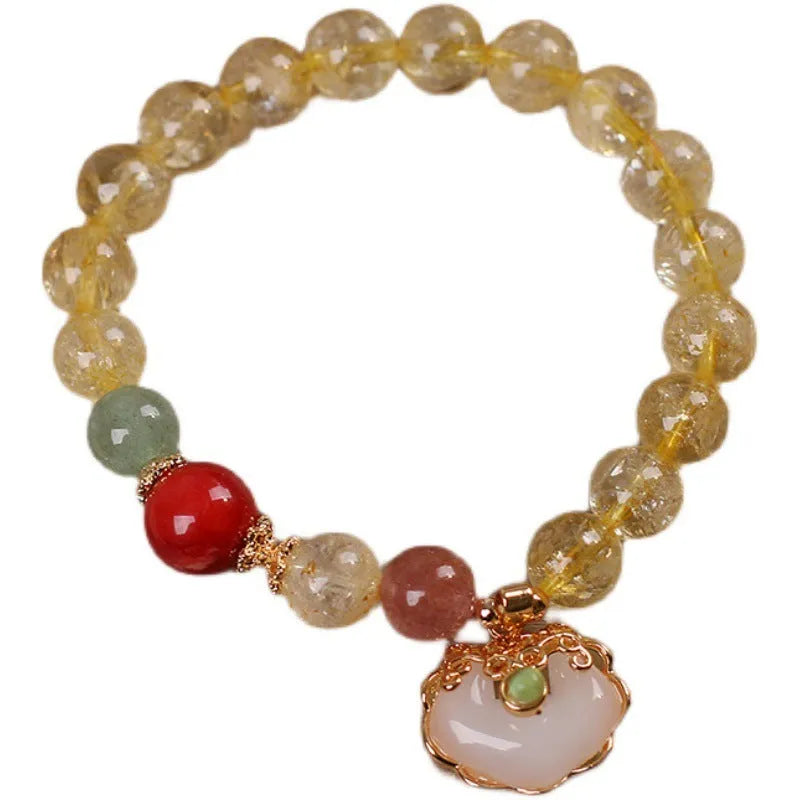 Yellow citrine jade ruyi pendant on an alloy women's bracelet.