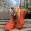 Women's flat slip-on loafers in PU leather with car suture detailing on the upper.