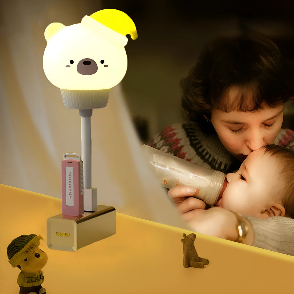Cartoon animal USB night light with remote control on a bedside table.