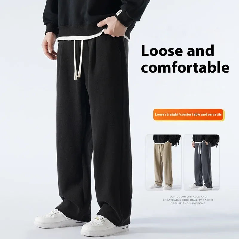 Man wearing loose apricot fleece-lined sports trousers with a drawstring waistband.