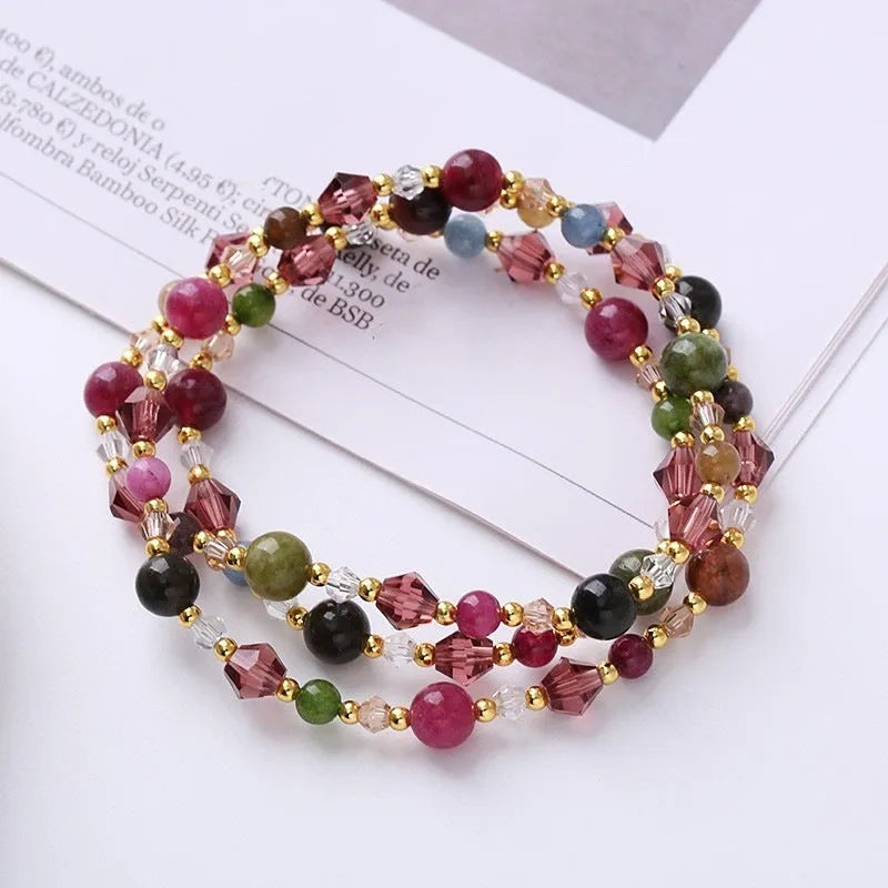 Women's adjustable crystal bracelet with three-ring beads on a cord in tourmaline, strawberry quartz, or amethyst