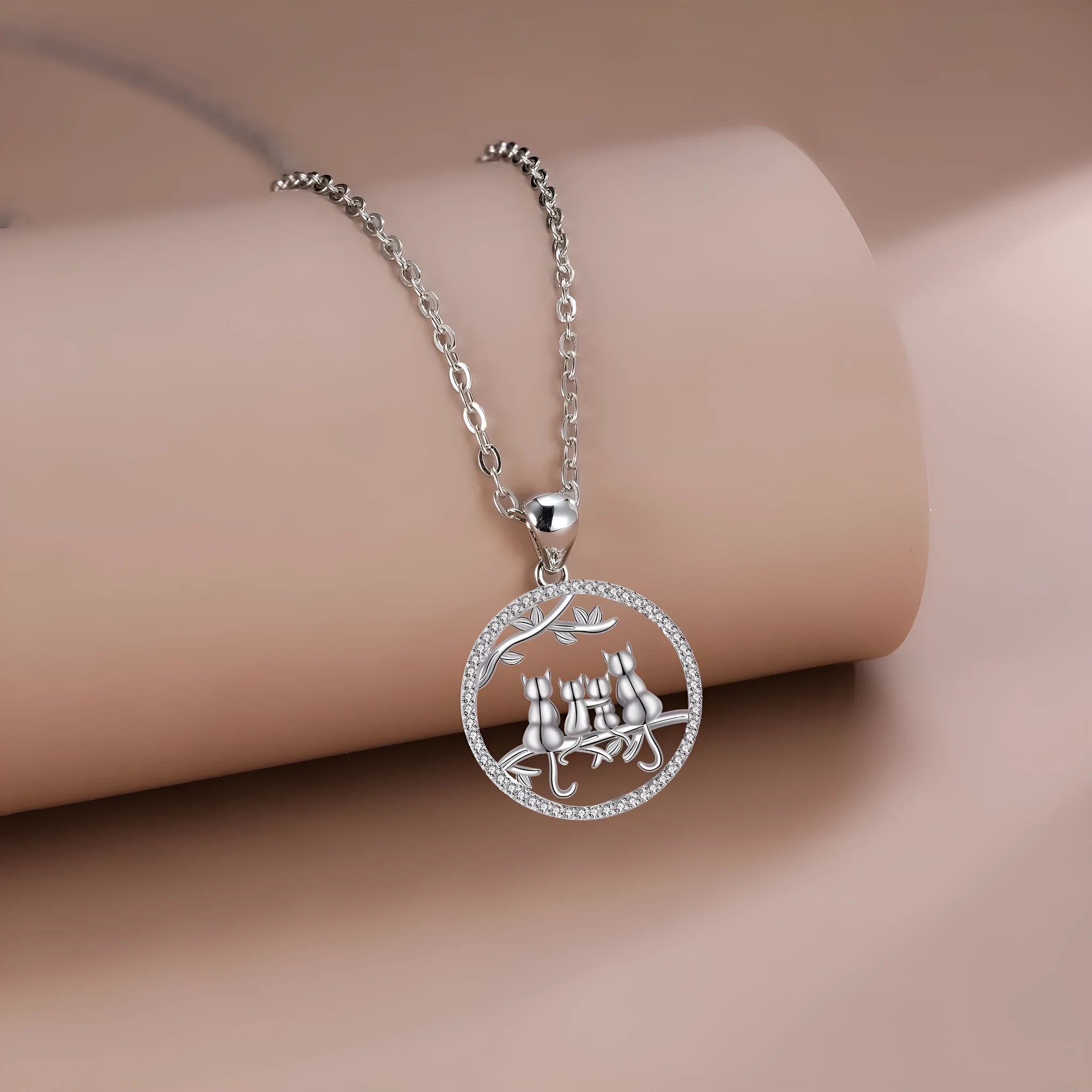 Women's copper necklace with an electroplated pendant showing four kittens on a cross chain.