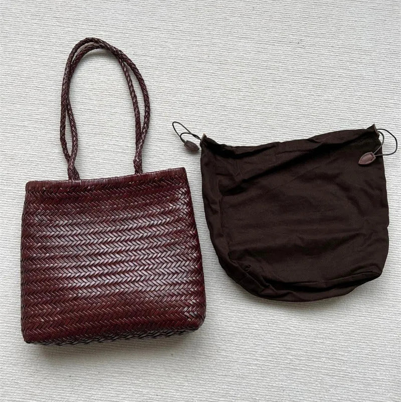 Brown woven genuine leather tote bag with a three-dimensional front pocket.