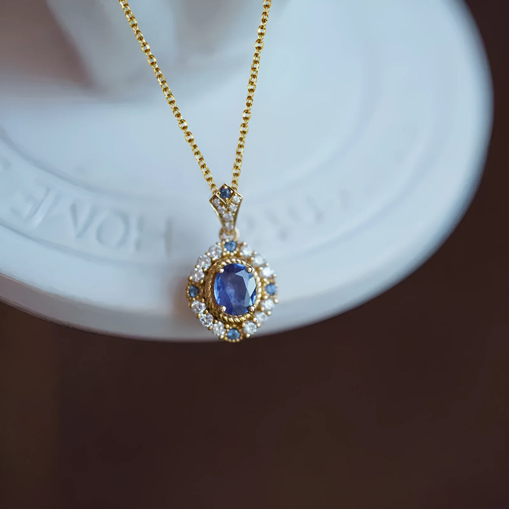 Yellow gold mixed gem pendant necklace with inlaid zircon stones on a box chain.