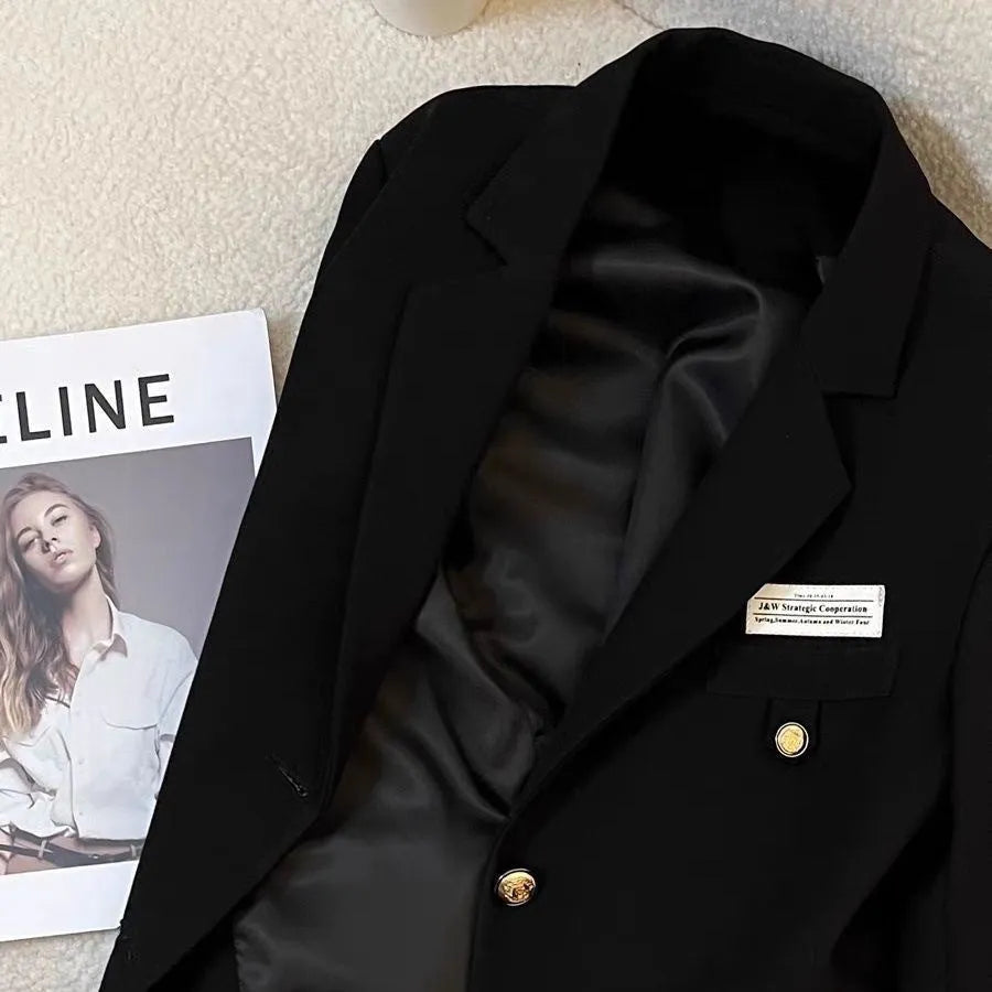 Black women's short suit coat with loose fit design and regular long sleeves