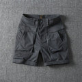Men's stretch cotton cargo shorts in army green, showing multiple pockets and straight-leg short cut.