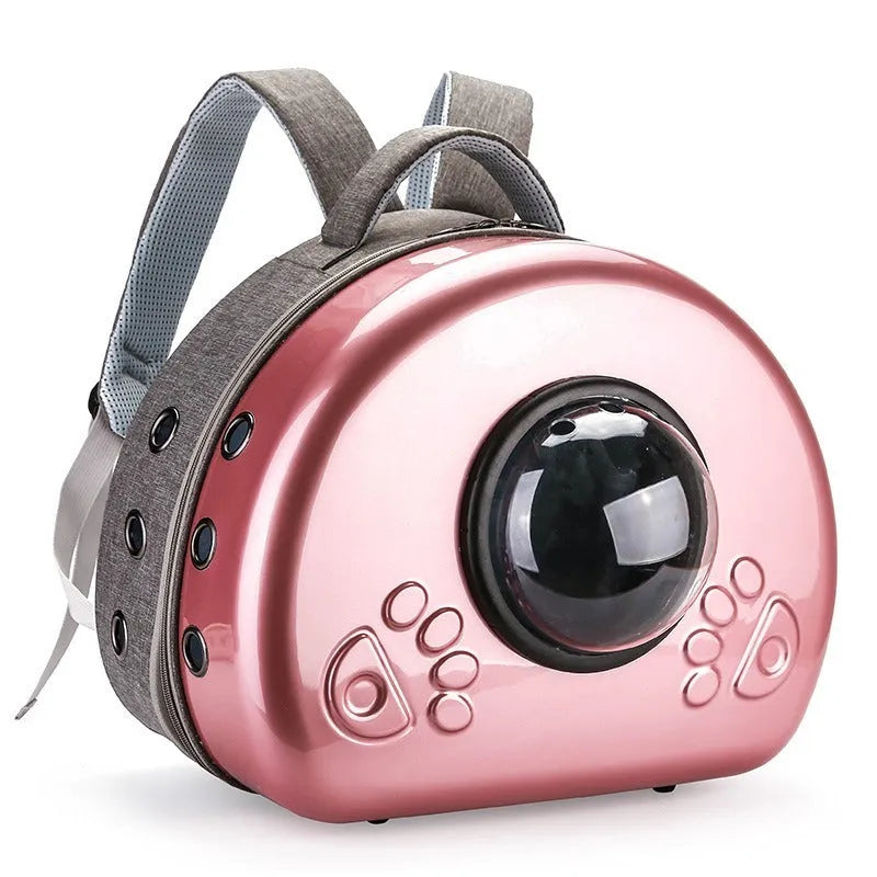 Transparent space capsule-style cat carrier bag with metallic-coloured front shell, on a white background.