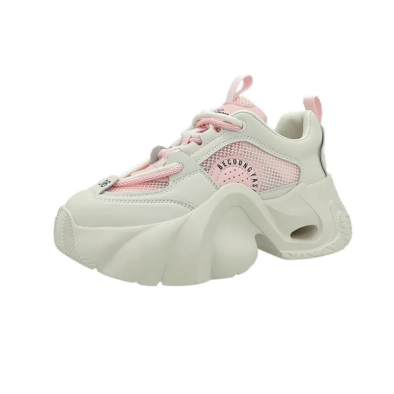 Women's pink casual sneakers with a cross strap, thick sole, and mesh lining on a white background.
