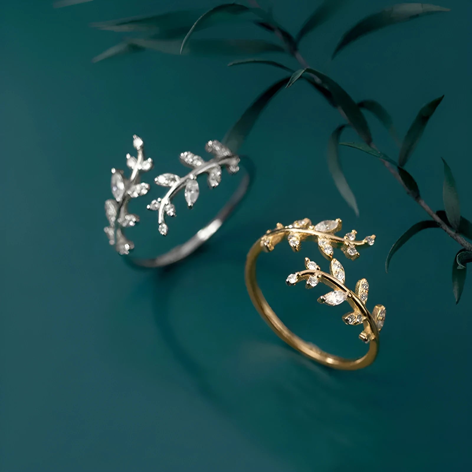 Close-up of a women's leaf-shaped branch fashion ring in a silver or gold electroplated finish on a copper base.