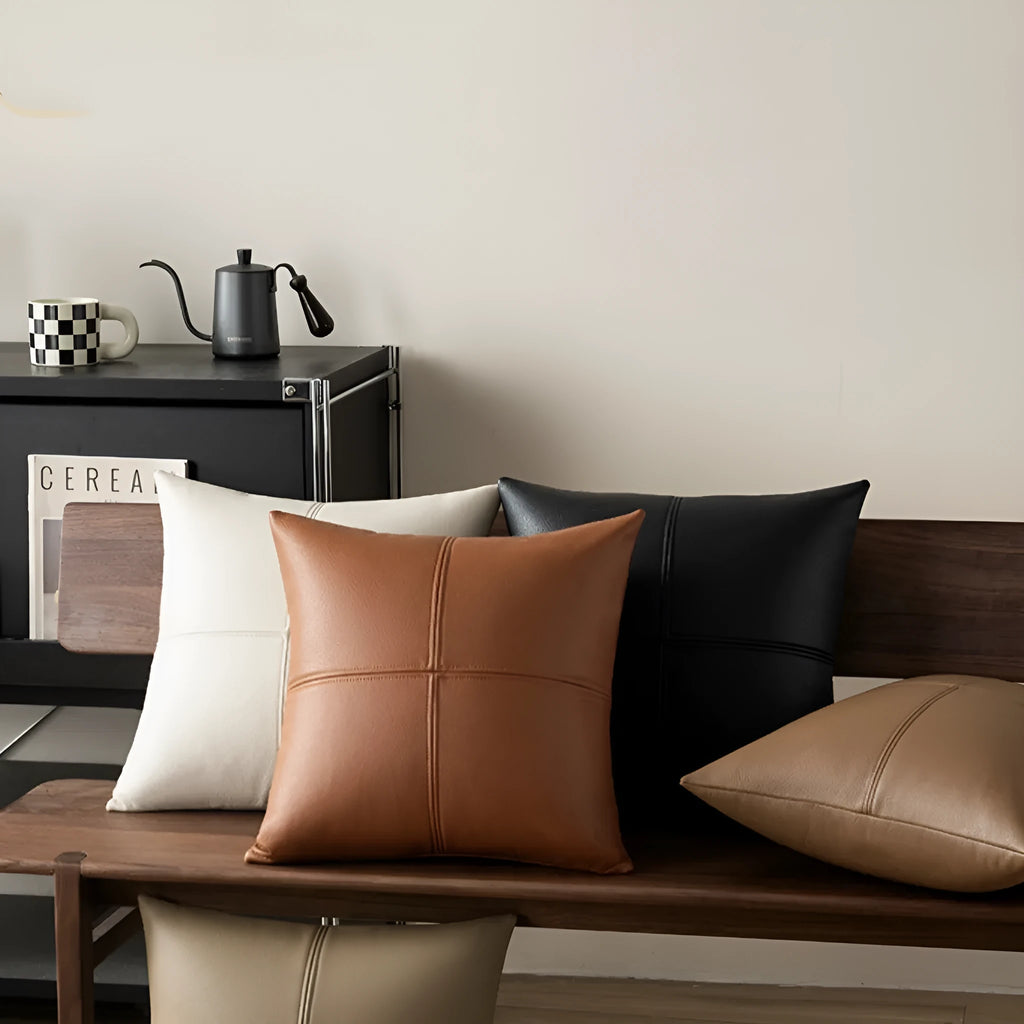 Solid colour cowhide leather pillow cover in Nordic style on a grey sofa.