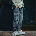 Blue men's loose straight-leg retro-style stretch denim trousers on a plain background.