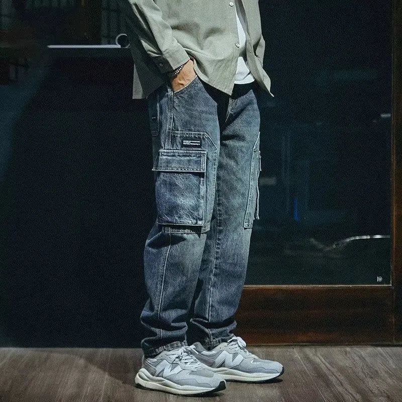 Blue men's loose straight-leg retro-style stretch denim trousers on a plain background.
