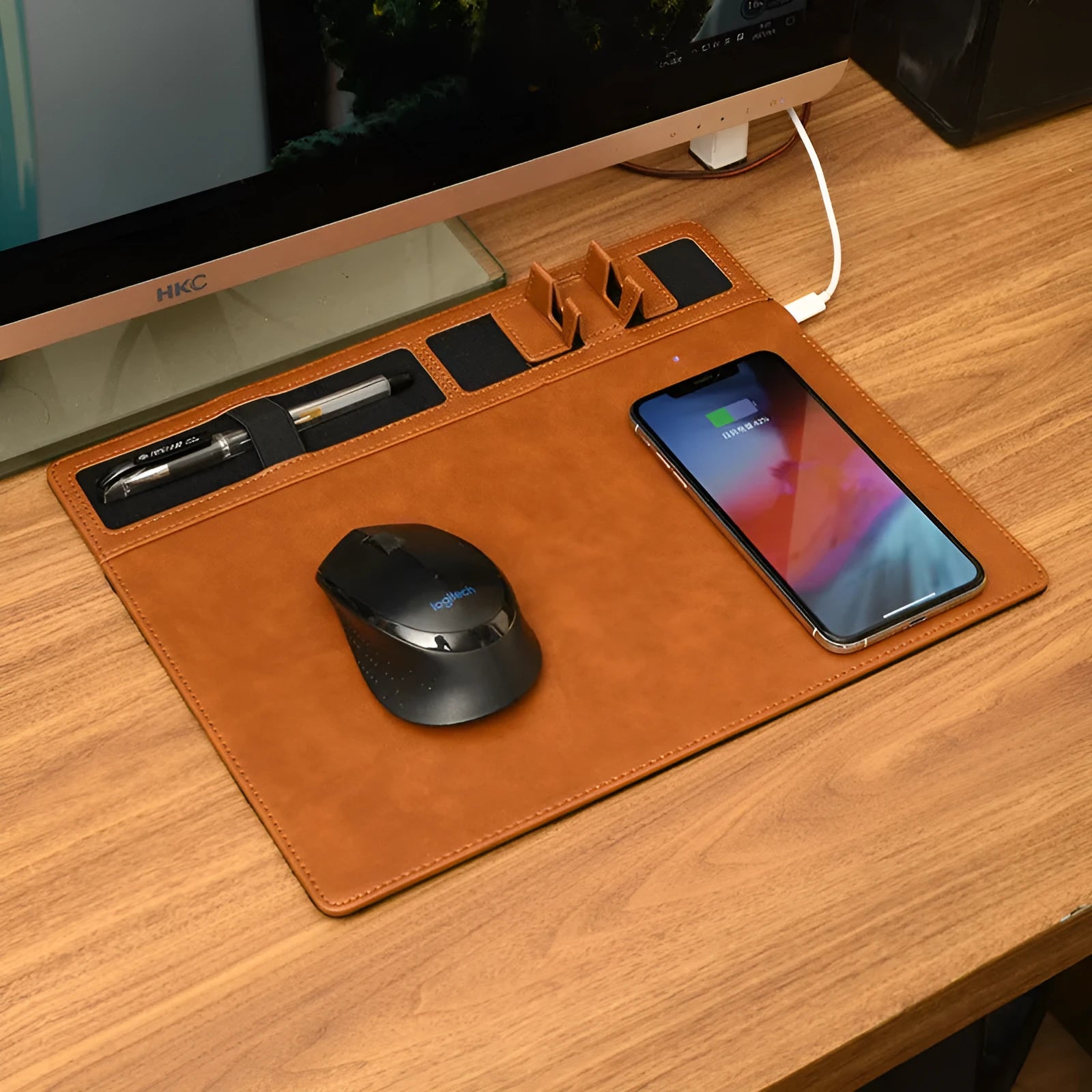 Pink multifunctional wireless charging mouse pad with integrated mobile phone holder on a desk