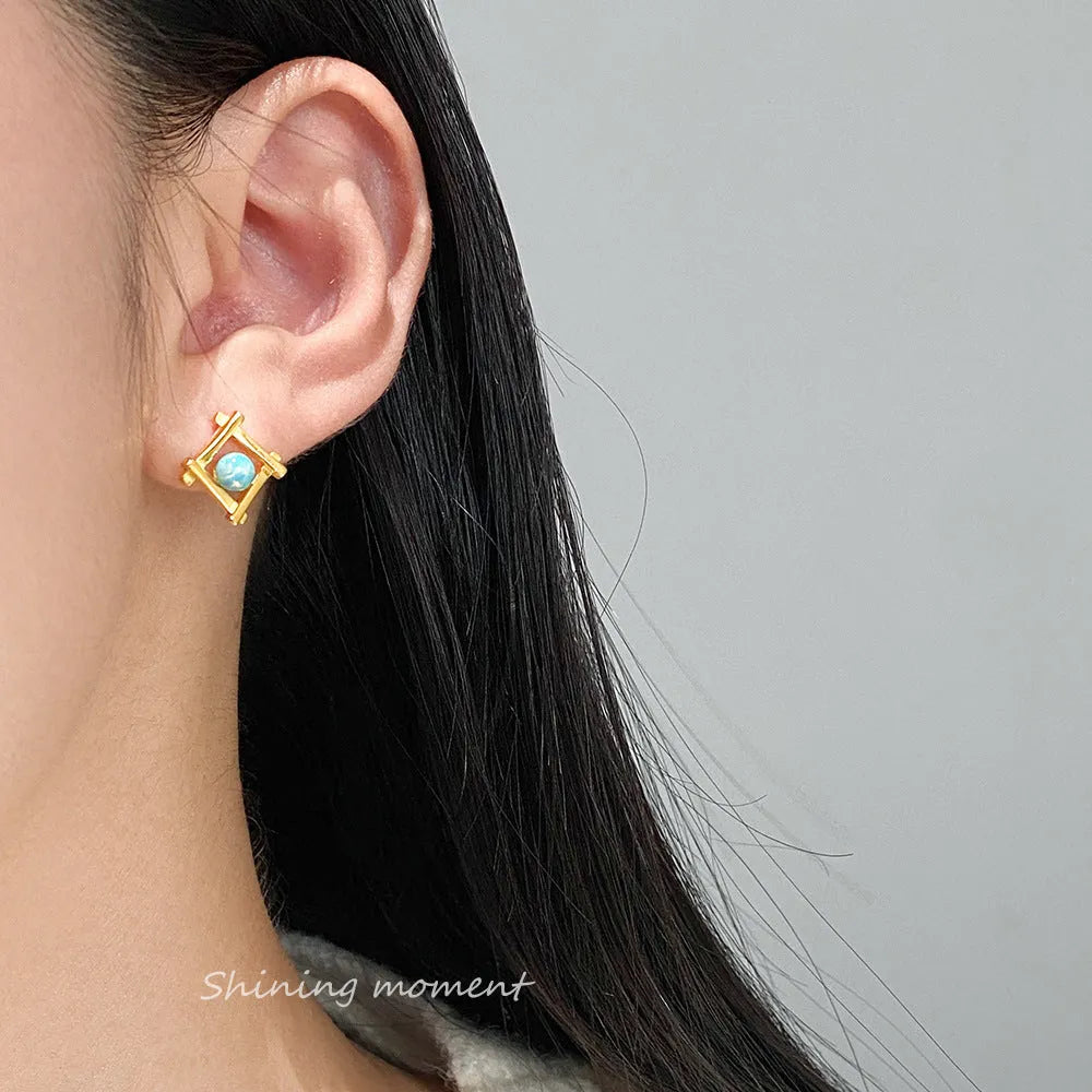 Geometric cross and quadrangle shape stud earrings for women in sterling silver.