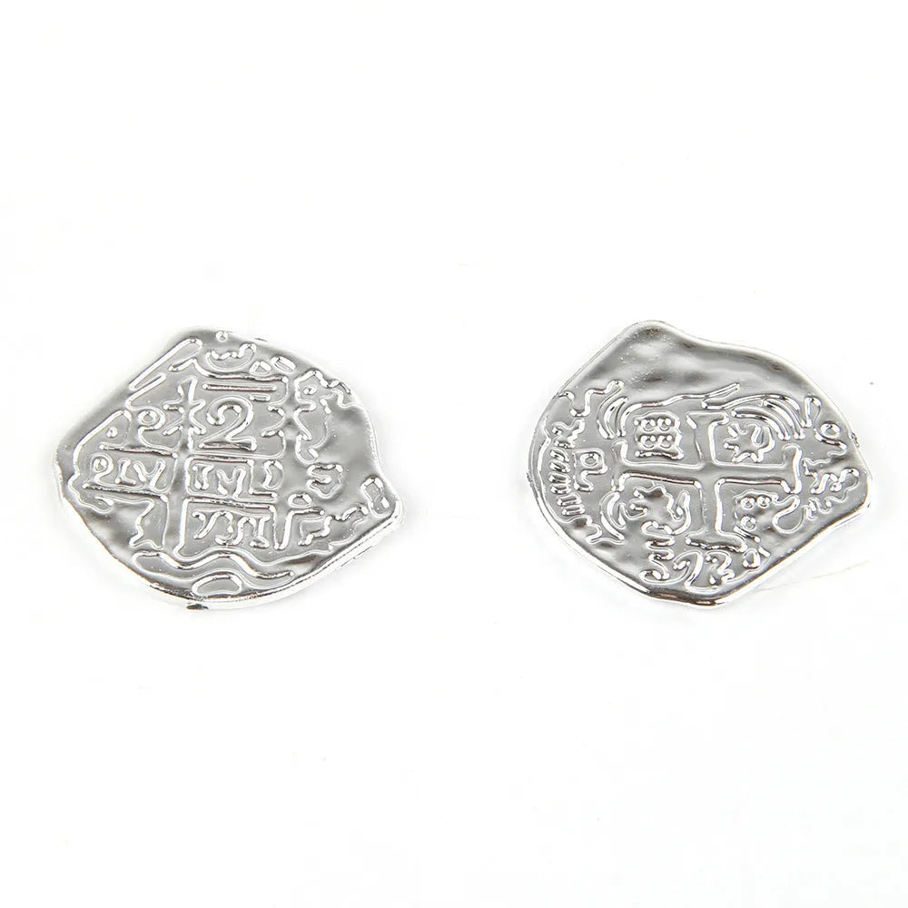 100 replica Roman pirate coins in gold, silver, and bronze finishes displayed together